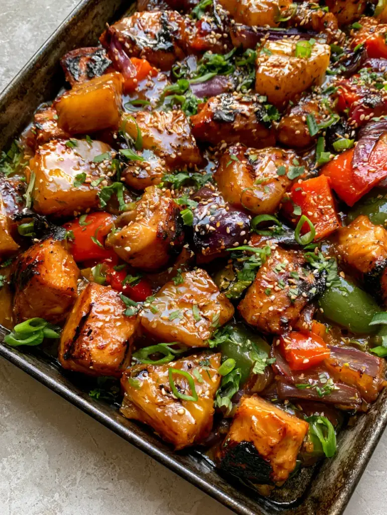 Gluten-free Hawaiian Chicken: The Ultimate Sticky One-Pan Dinner 1 Close-up of caramelized pineapple with grill marks and seared chicken in a Gluten-free Hawaiian Chicken dish.